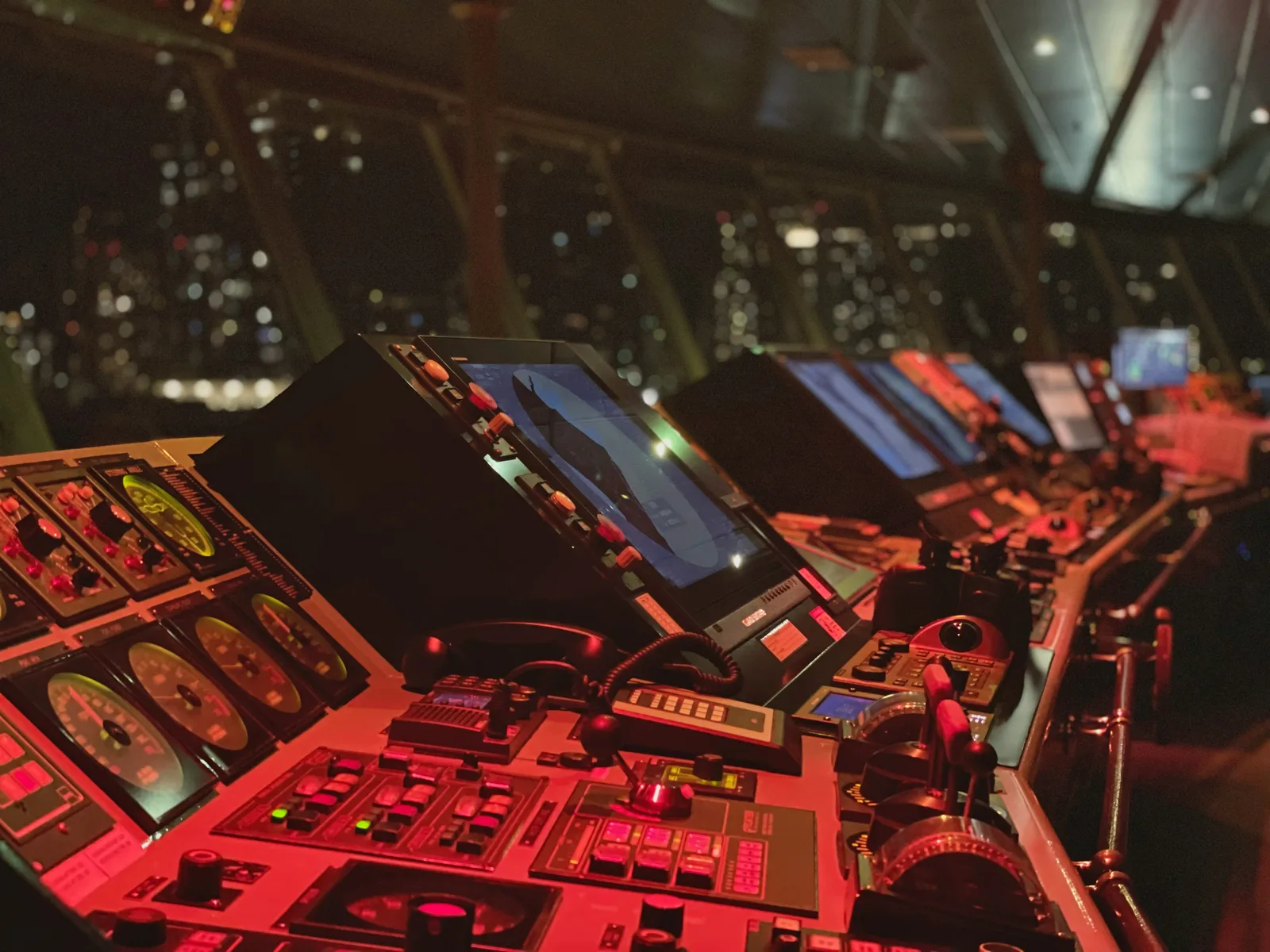A ship's navigation bridge filled with radar and chart displays.