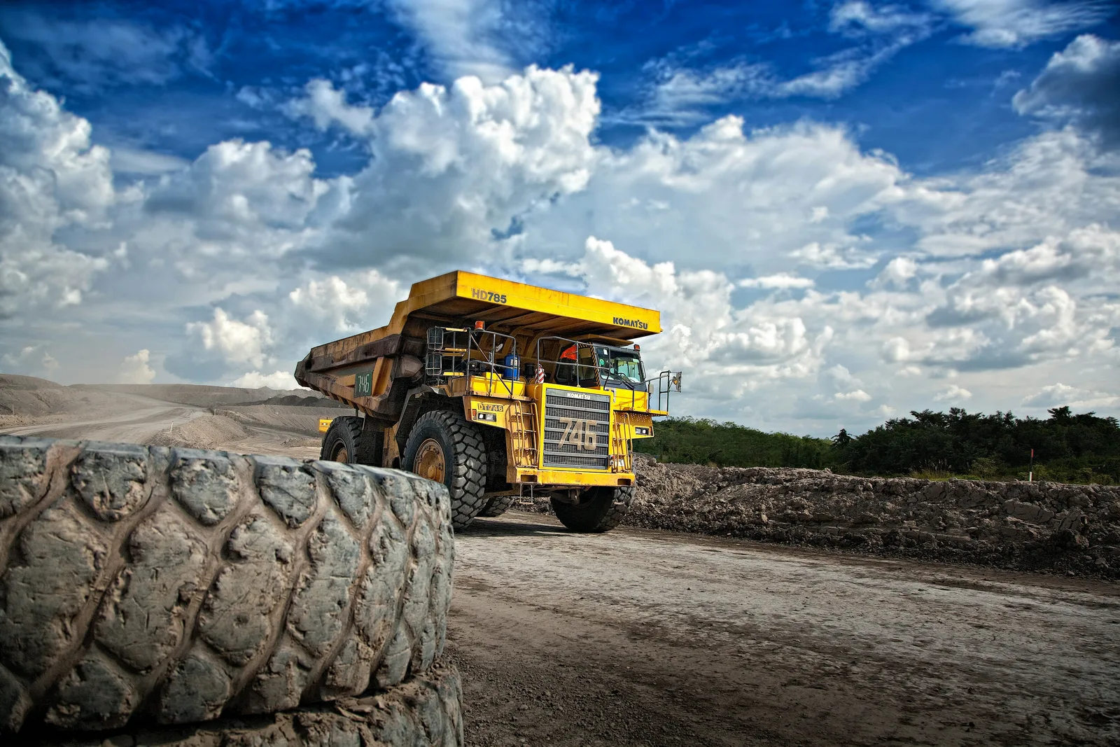 A loaded haul truck on a mine haul road below arid ranges.