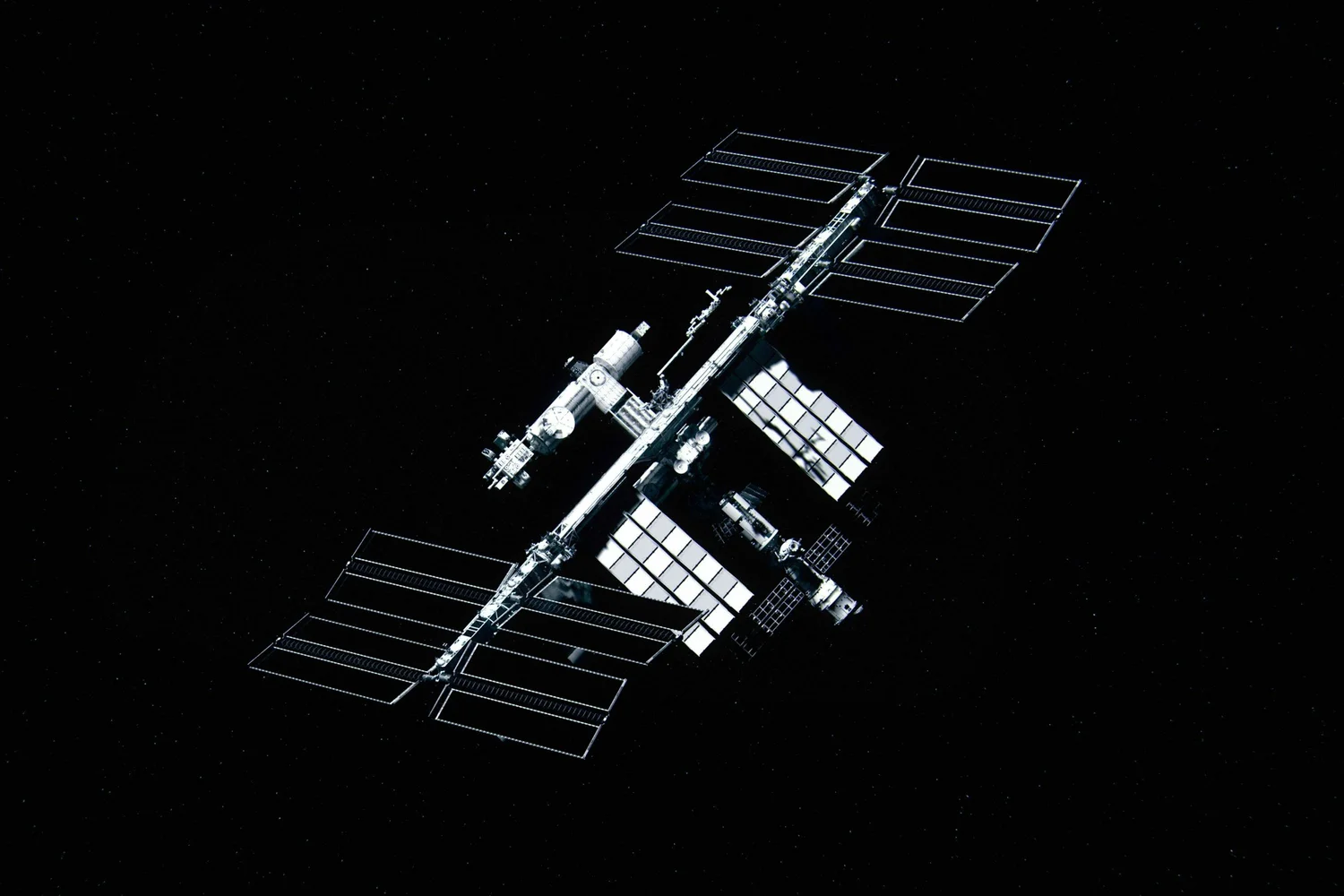 A satellite in orbit above Earth against a star field.