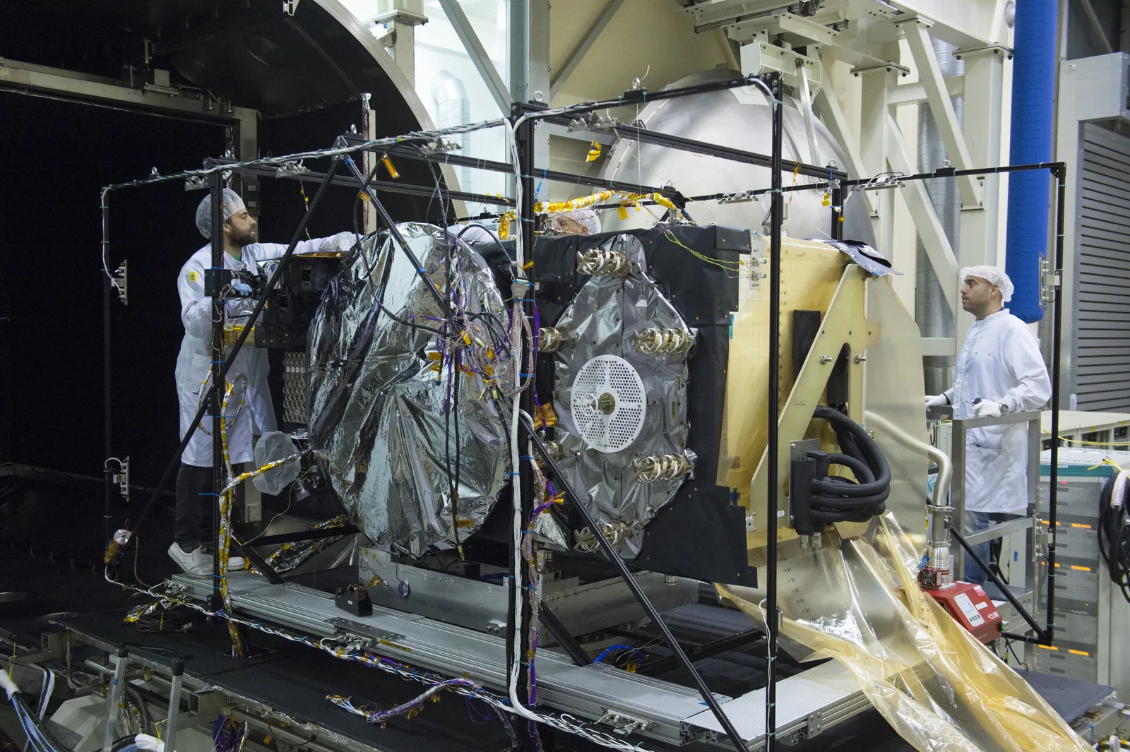 A Galileo navigation satellite being removed from a thermal-vacuum test chamber.